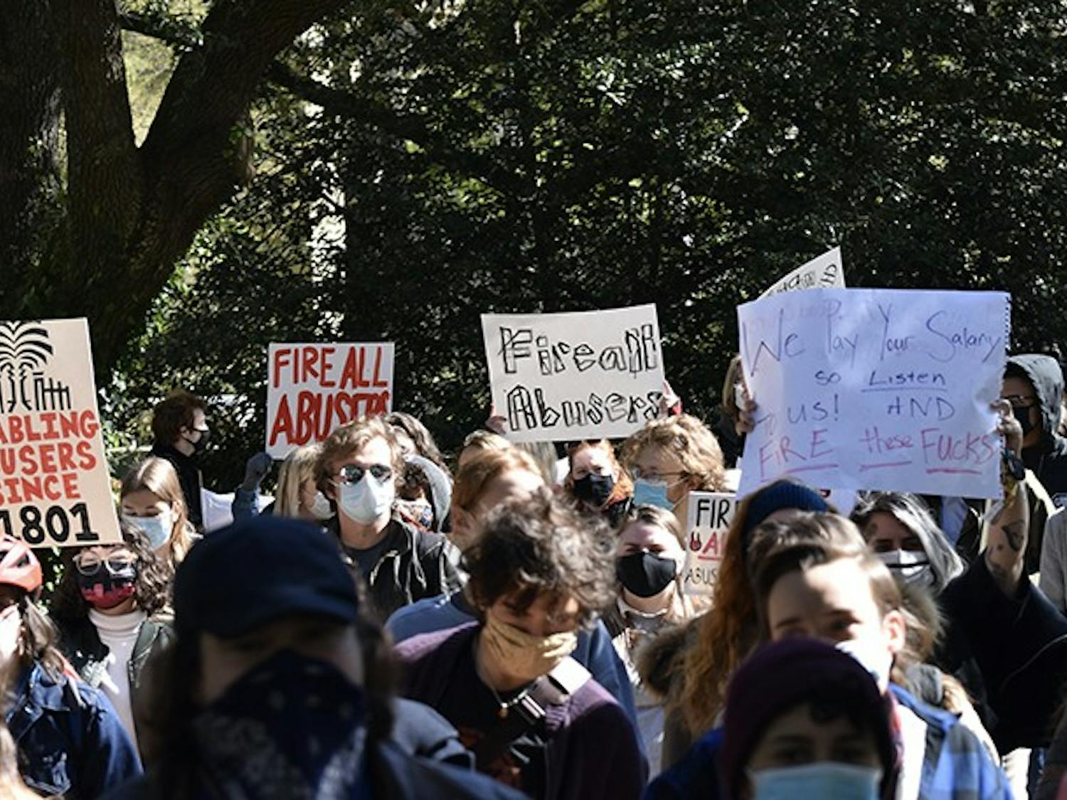 Protestors march from Pickens Street Bridge to the President's House holding signs that demand the firing of all professors accused of sexual misconduct.&nbsp;