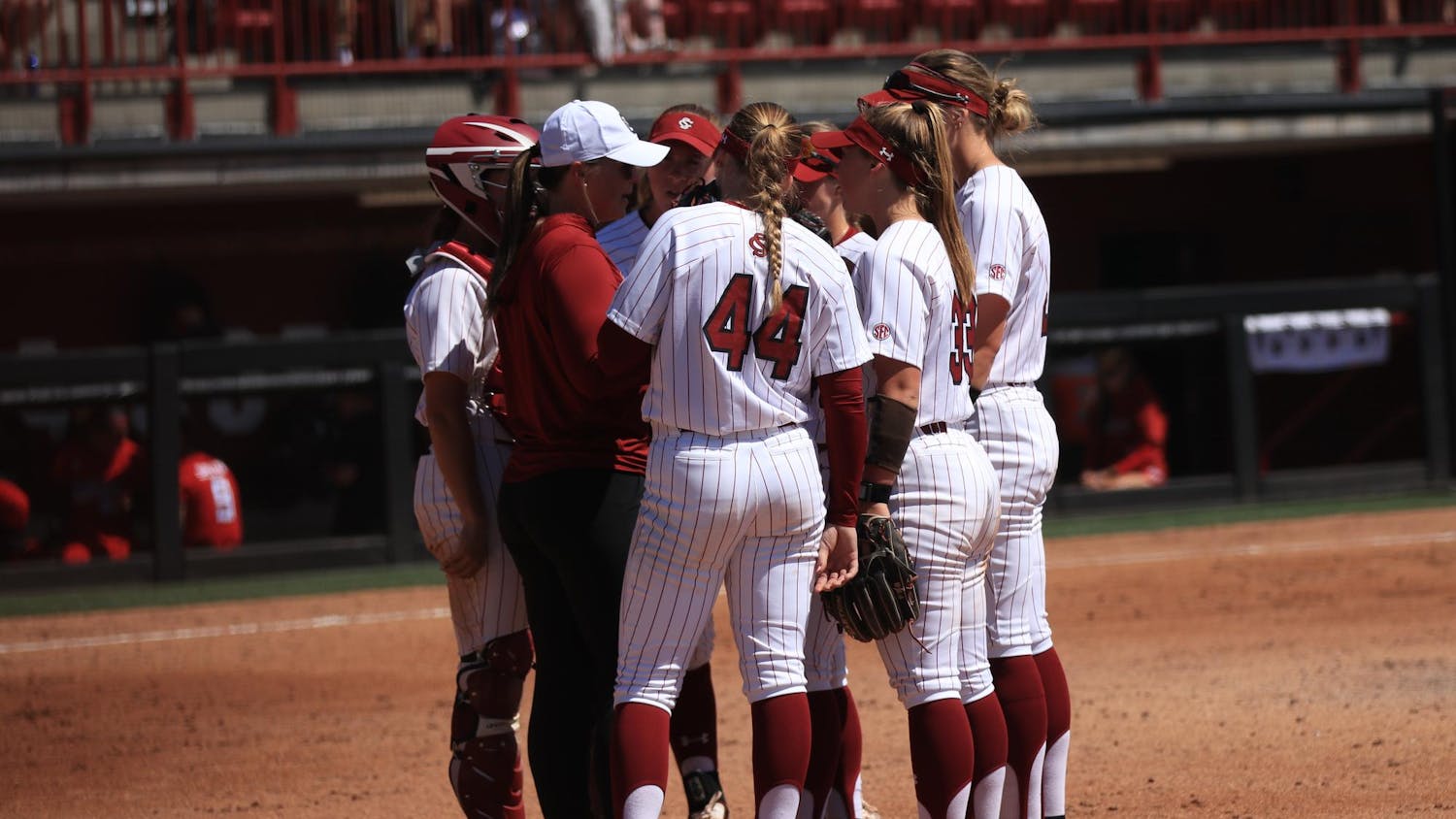 The University of South Carolina softball team gathers together during a changeover at Carolina Softball Stadium on Mar. 23, 2025. The Gamecocks lost to the Texas Tech Red Raiders, 5-6, in a close matchup. 