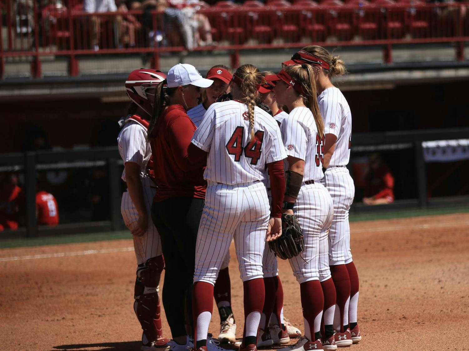 The University of South Carolina softball team gathers together during a changeover at Carolina Softball Stadium on Mar. 23, 2025. The Gamecocks lost to the Texas Tech Red Raiders, 5-6, in a close matchup. 