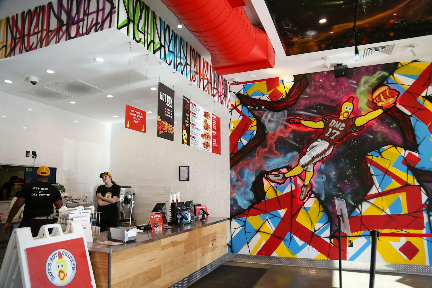 The main counter and wall mural on display inside Dave's Hot Chicken at 4601 Devine St. in Columbia, South Carolina on Oct. 17, 2023. This restaurant is the business's first location in South Carolina.