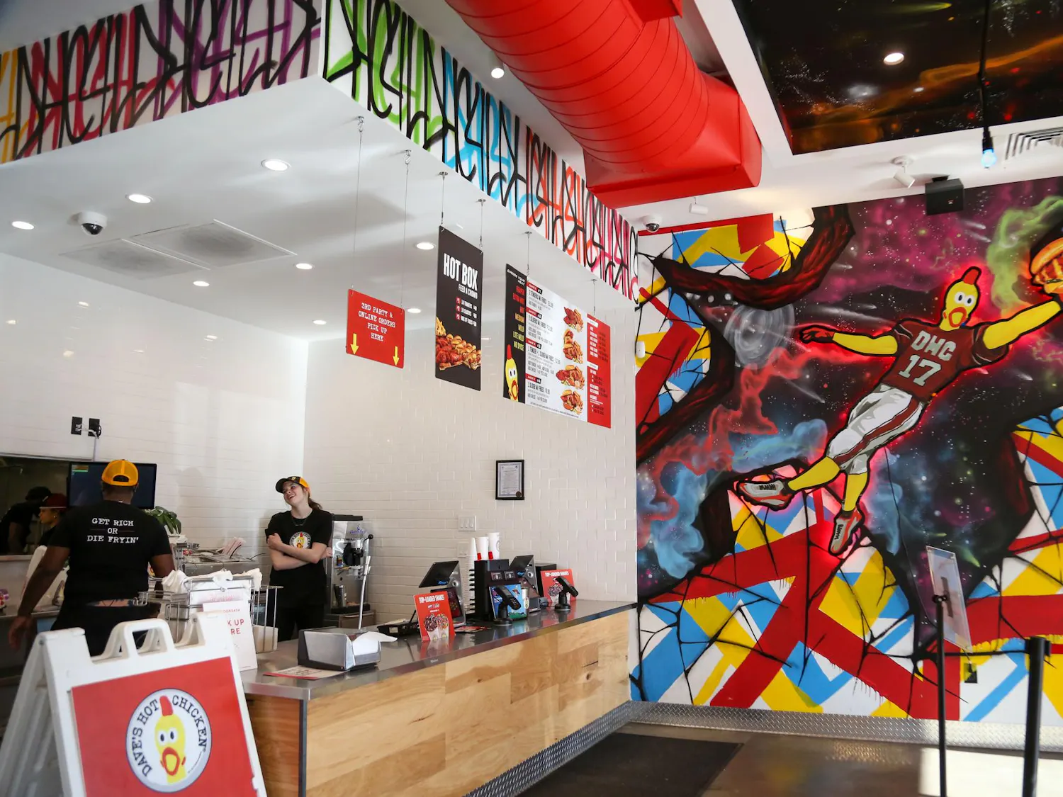 The main counter and wall mural on display inside Dave's Hot Chicken at 4601 Devine St. in Columbia, South Carolina on Oct. 17, 2023. This restaurant is the business's first location in South Carolina.