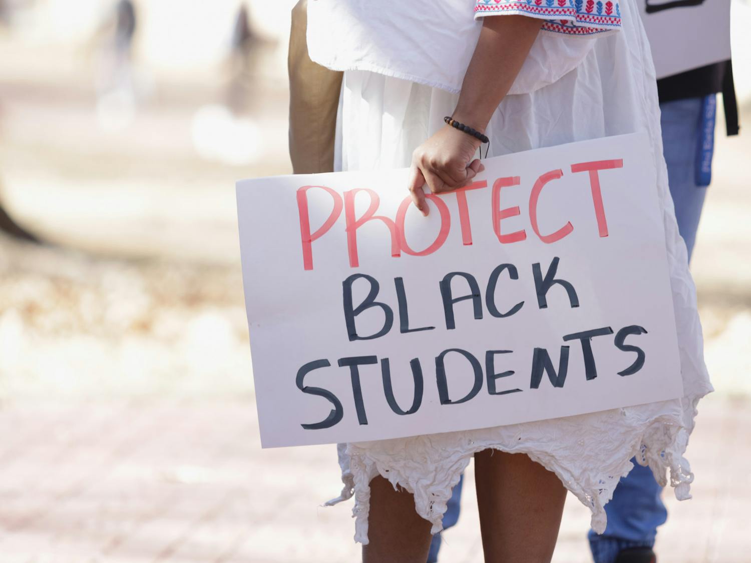 A protestor on the Horseshoe holds a sign that reads "PROTECT BLACK STUDENTS" on Jan. 20, 2023. The protest was organized by Courtney McClain, a fourth-year broadcast journalism student and the president of the SC NAACP Y&amp;C Division.