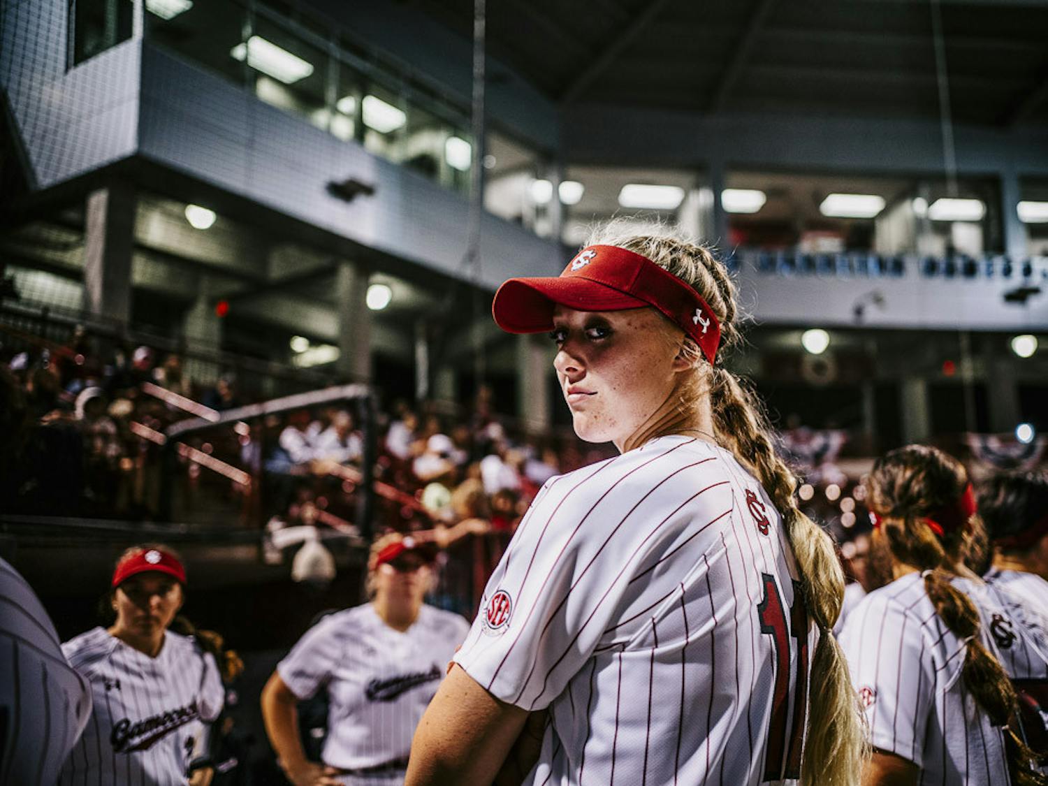 Fifth-year outfielder Haley Simpson peaks back at the camera during player introductions at the South Carolina vs. College of Charleston game on February 15, 2023. The Gamecocks beat the Cougars 8-0.&nbsp;
