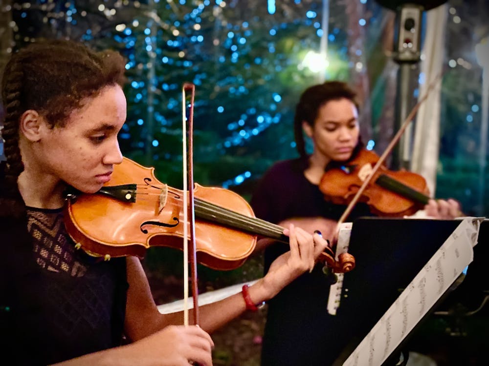 <p>Sisters Slawka (left) and Danka Ndubuis (right) perform at a SoundBites fundraising event in December 2021. Both musicians are students at the Suzuki Academy of Columbia, located at 400 State St. in West Columbia.&nbsp;</p>