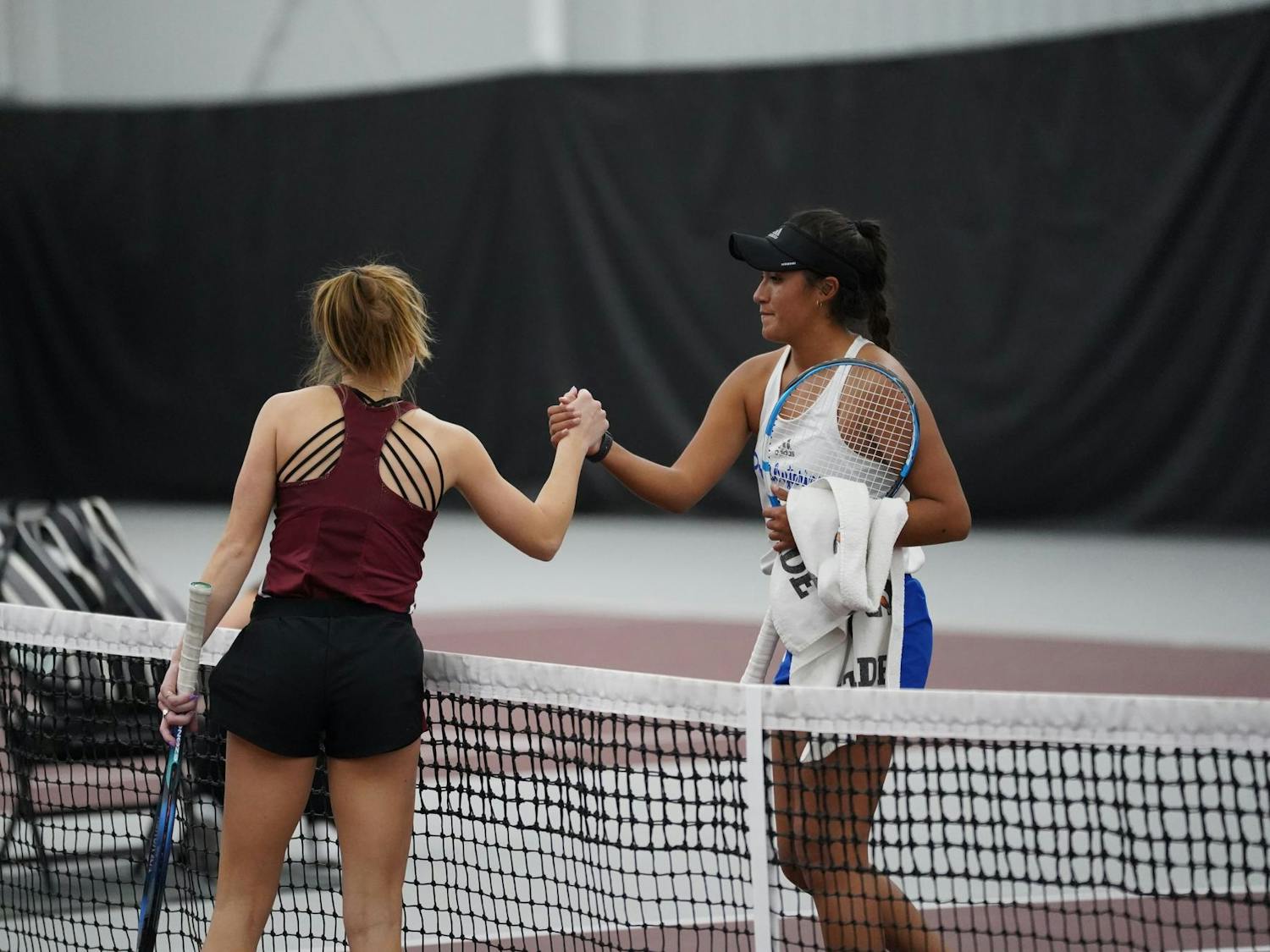 Junior Sarah Hammer meets her opponent at the net to conclude their singles match on Jan. 21, 2024. The Gamecocks went on to defeat the Blue Hoses 4-0.