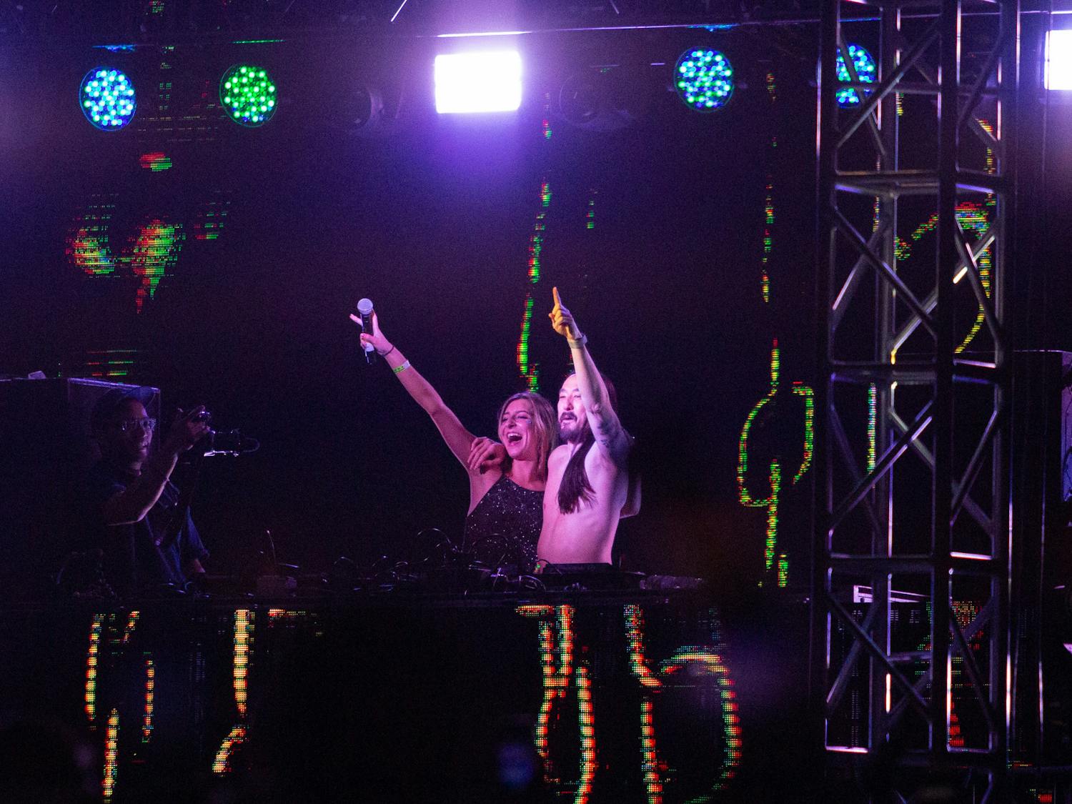Steve Aoki and fan pose for the crowd after he allowed her to come on stage, if only she could rap Lose Yourself by Eminem. Aoki was the primary headliner for the Hidden City Music Festival on April 22, 2023 at the Columbia Historic Speedway.&nbsp;