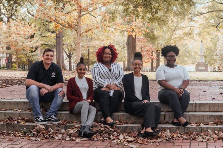 From left to right: Bradley Barker, A'ya Hall, Alyssia Ross, Yaunna Hunter and Kailah Green pose for a photo at the Horseshoe. The group makes up a portion of the Association of Transfer Students, an organization that provides support and community for transfer students of all ages.