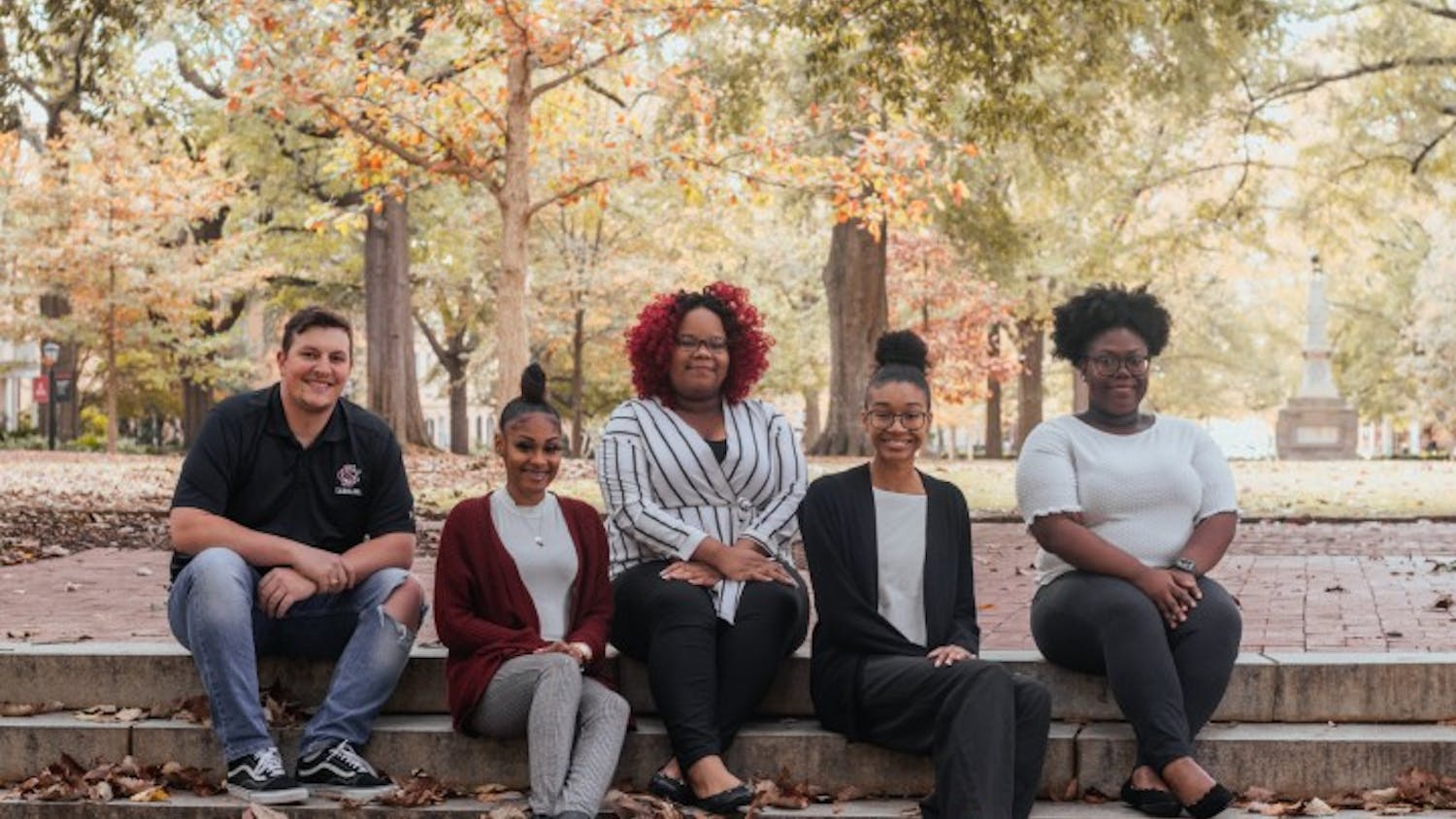 From left to right: Bradley Barker, A'ya Hall, Alyssia Ross, Yaunna Hunter and Kailah Green pose for a photo at the Horseshoe. The group makes up a portion of the Association of Transfer Students, an organization that provides support and community for transfer students of all ages.
