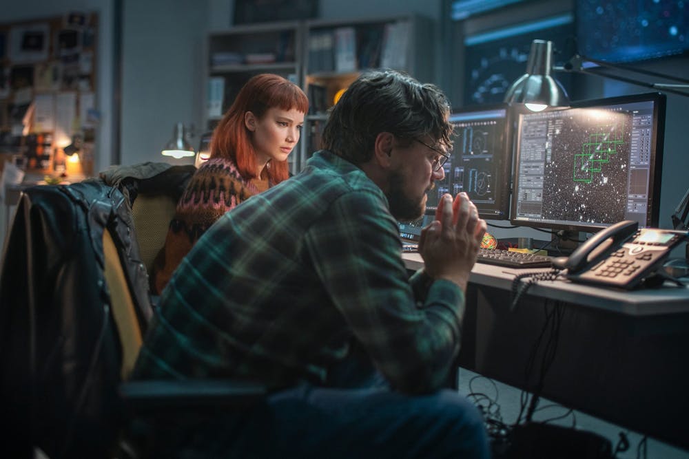 <p>Jennifer Lawrence, left, and Leonardo DiCaprio, right, play scientists who make a shocking discovery, and then have to convince the rest of the planet of it, in Adam McKay's "Don’t Look Up." (Niko Tavernise/Netflix/TNS)</p>