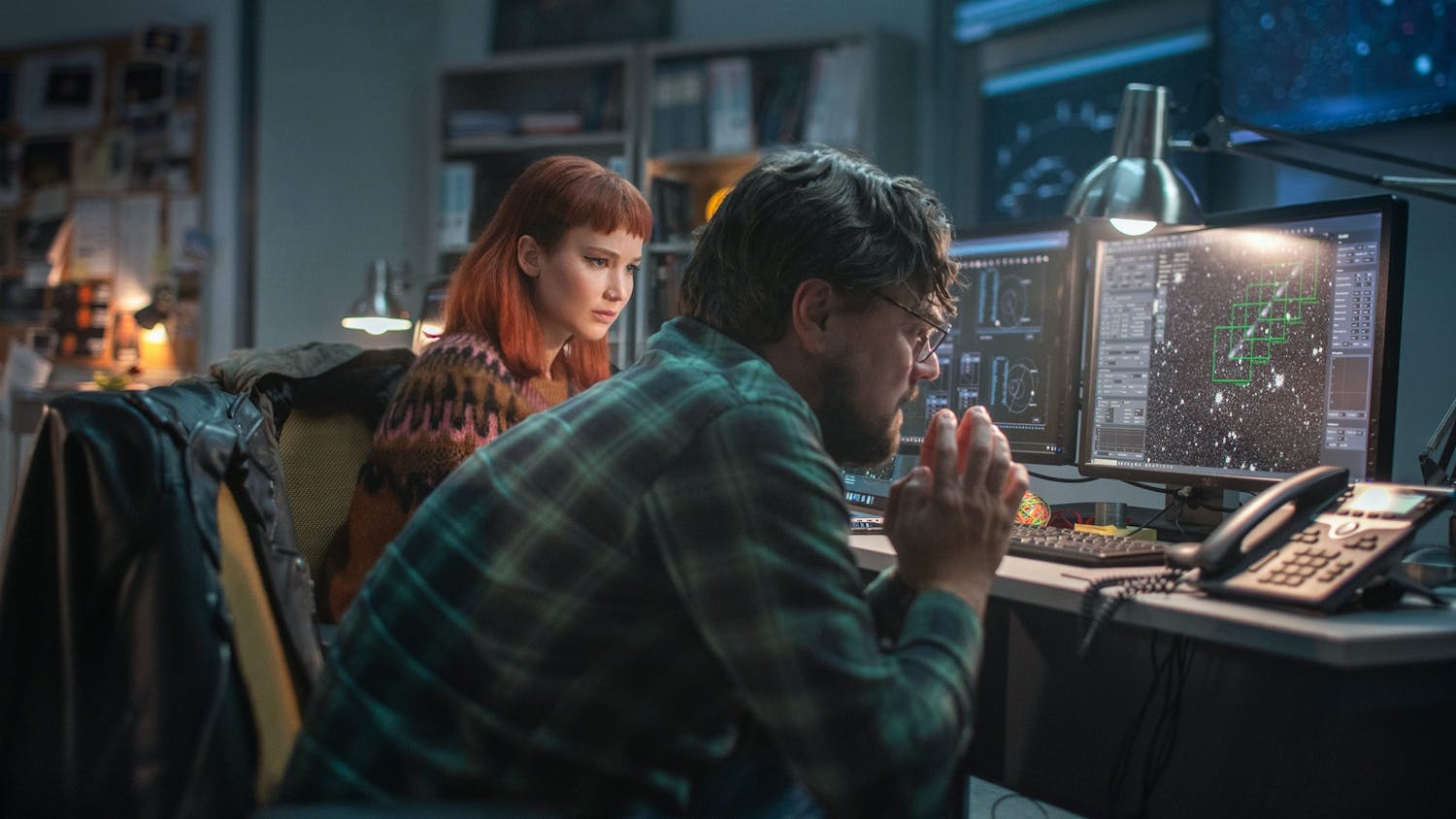 Jennifer Lawrence, left, and Leonardo DiCaprio, right, play scientists who make a shocking discovery, and then have to convince the rest of the planet of it, in Adam McKay's "Don’t Look Up." (Niko Tavernise/Netflix/TNS)