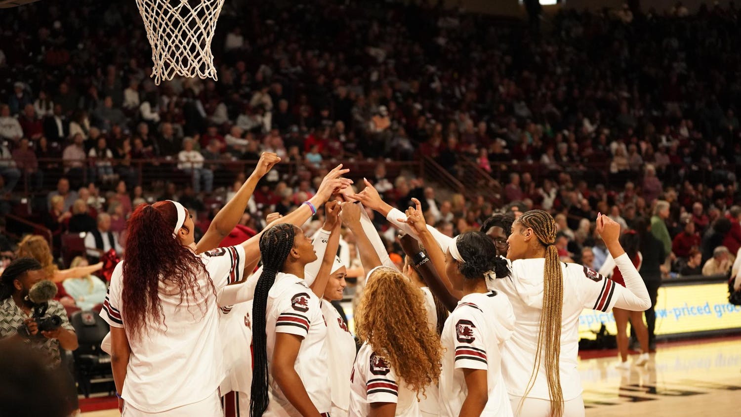 Gamecock women's basketball players huddle under the hoop before tip-off for South Carolina's game against Georgia on Feb. 18, 2024, at Colonial Life Arena. The Gamecocks improved to 25-0 after defeating the Bulldogs 70-56.