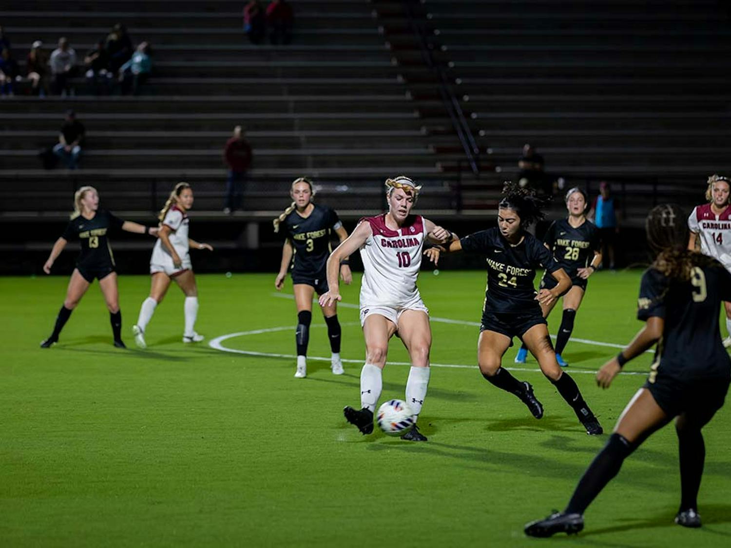 Junior forward Catherine Barry keeps contact with the ball while Wake Forest opponents close in. Barry contributed to the score, making one goal against Wake Forest at Stone Stadium on Nov. 12, 2022.