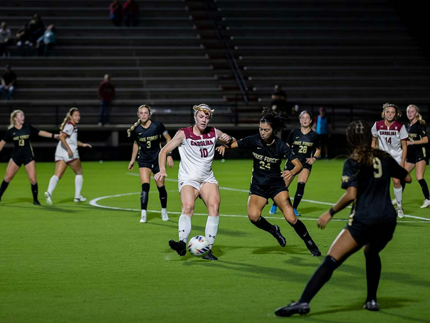 Junior forward Catherine Barry keeps contact with the ball while Wake Forest opponents close in. Barry contributed to the score, making one goal against Wake Forest at Stone Stadium on Nov. 12, 2022.