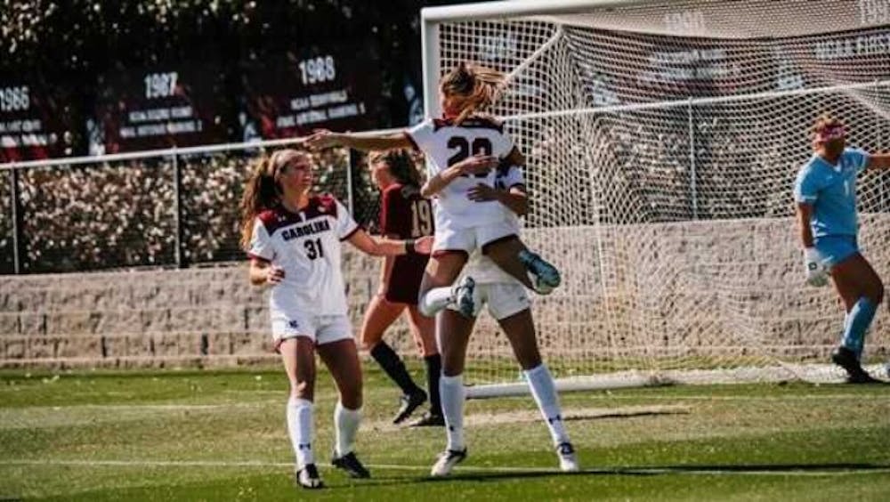 Members of the South Carolina women’s soccer team celebrate a goal in their Sunday win over College of Charleston.