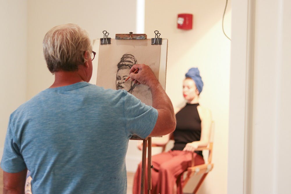 An artist sketches model Rachel Burns at the About Face event at 701 Whaley, 10 September 2019.