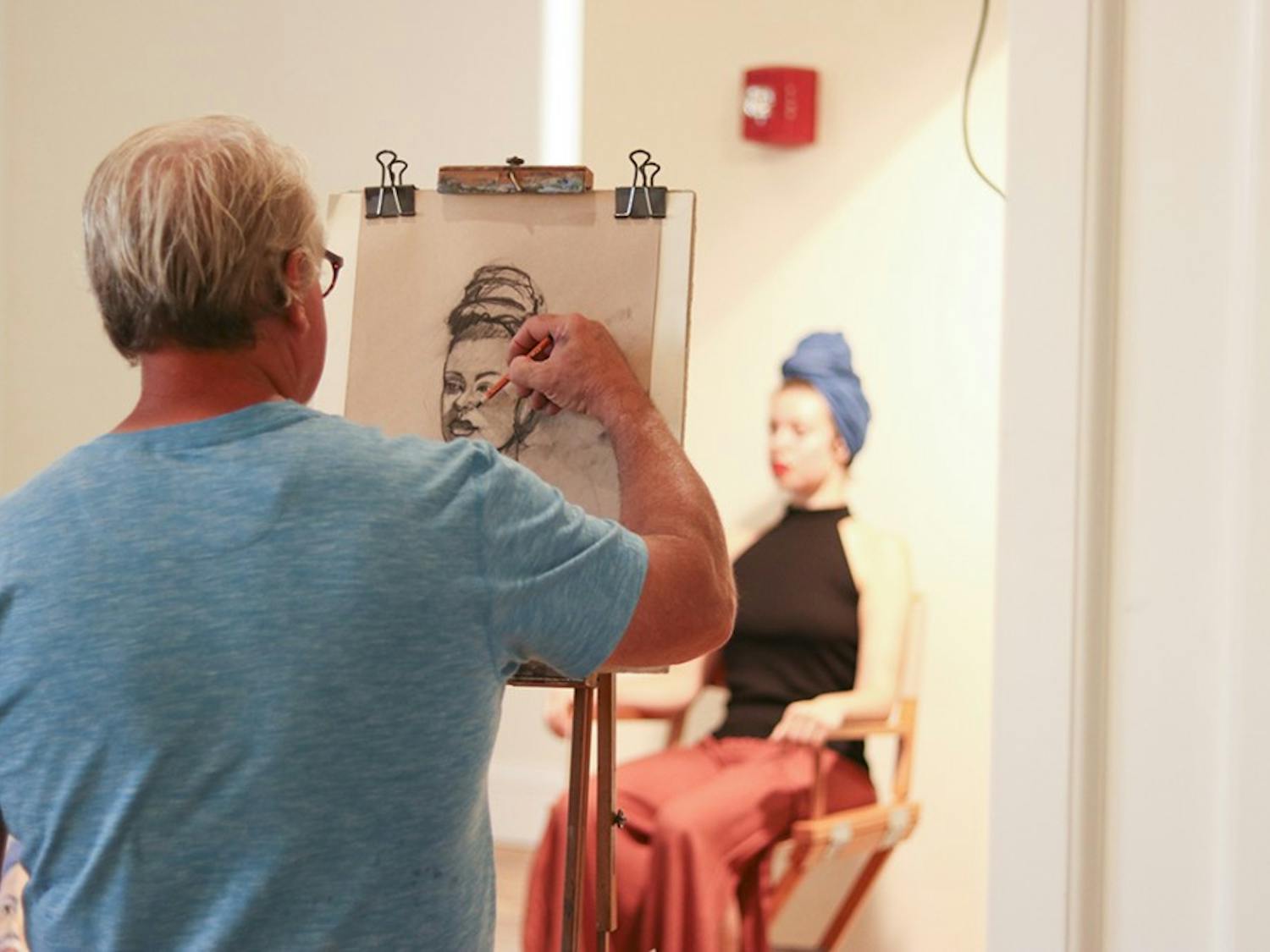 An artist sketches model Rachel Burns at the About Face event at 701 Whaley, 10 September 2019.