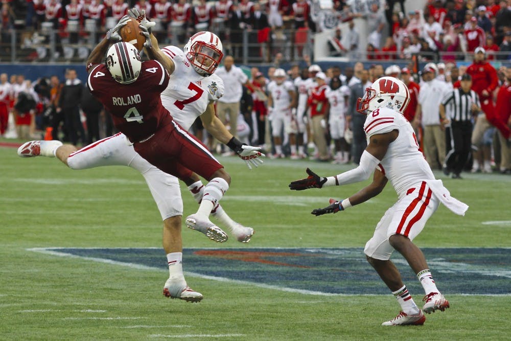 	Sophomore wide-out Shaq Roland brings down an improbable catch in traffic, one of his six grabs in South Carolina&#8217;s 34-24 win over Wisconsin in the 2014 Capital One Bowl.