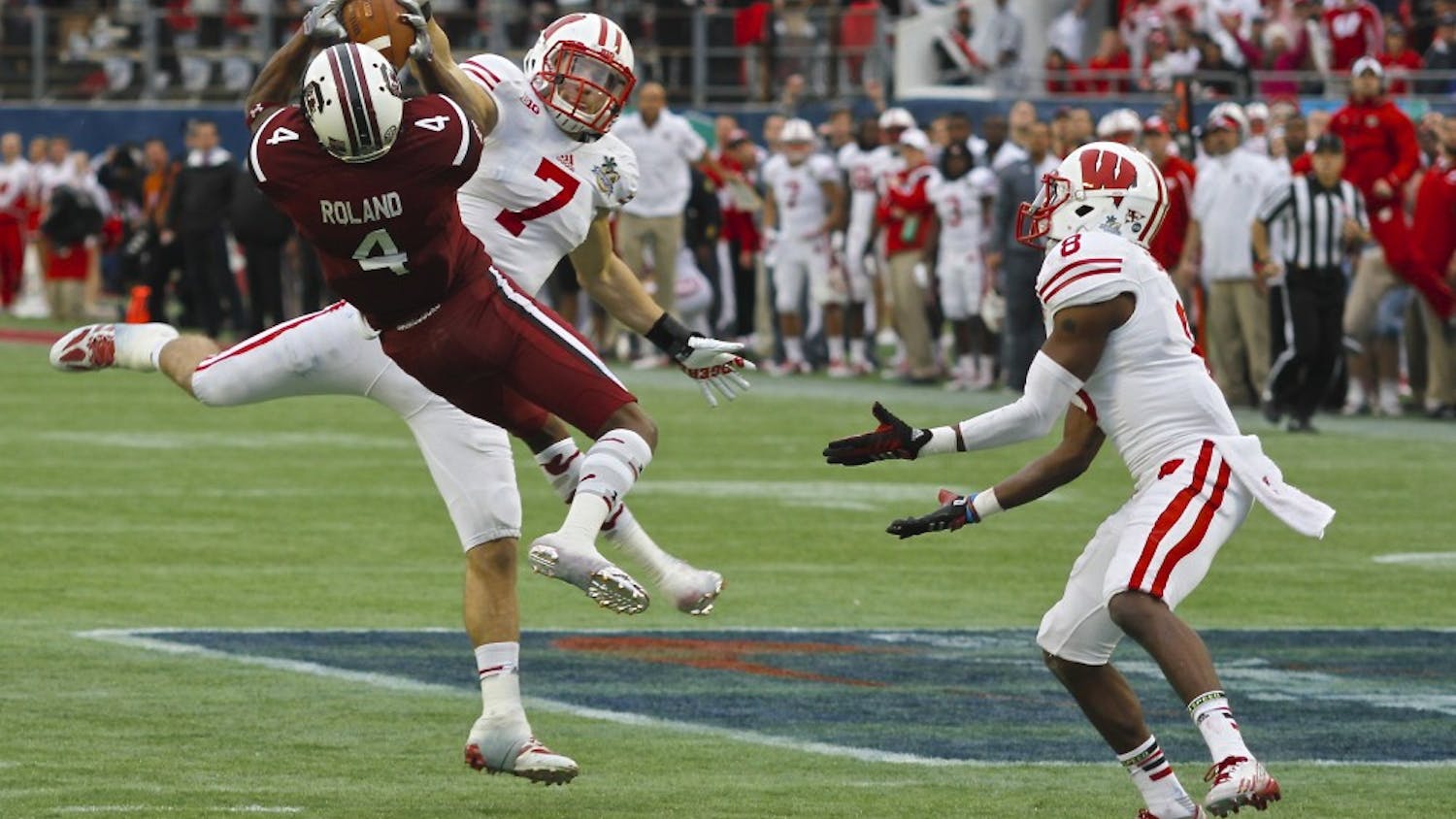 	Sophomore wide-out Shaq Roland brings down an improbable catch in traffic, one of his six grabs in South Carolina&#8217;s 34-24 win over Wisconsin in the 2014 Capital One Bowl.