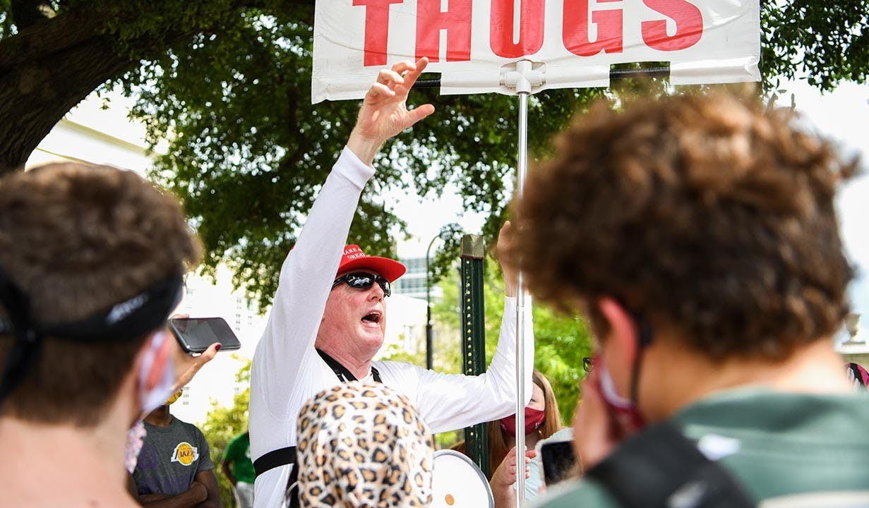 Jim Gilles preaches to students protesting his presence on Greene Street Friday, Aug. 21. &nbsp;Police were present across the street.