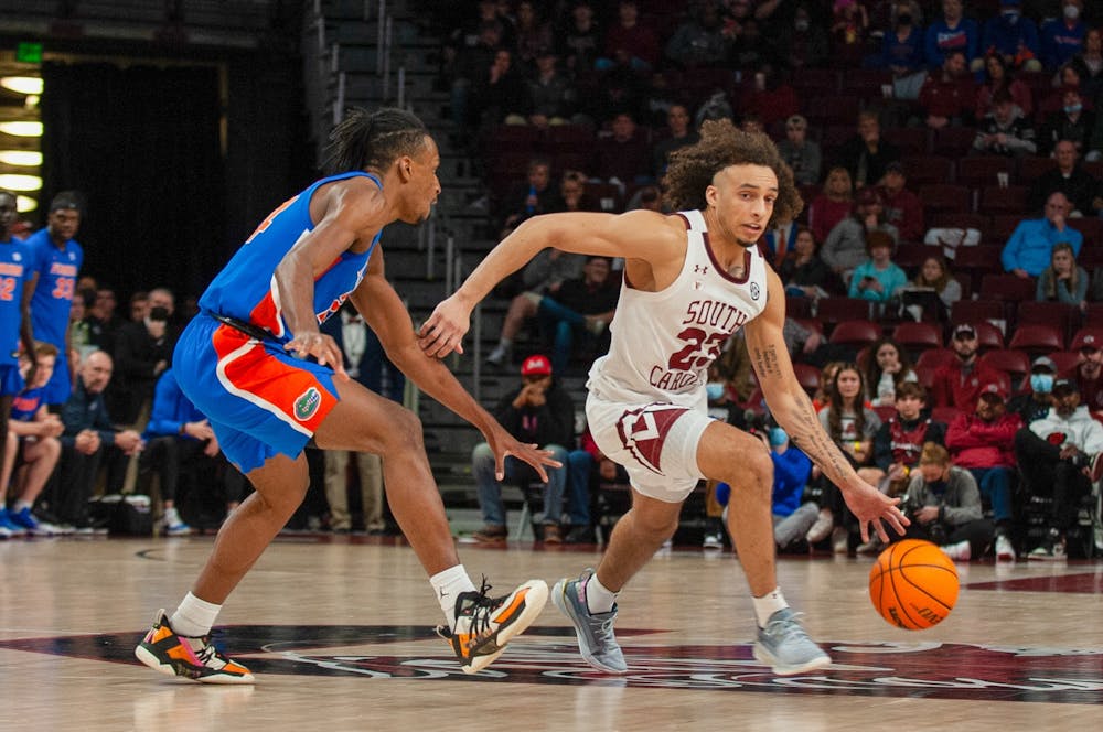 <p>Freshman guard Devin Carter dribbles the ball around the defense in a conference game against the Florida Gators on Saturday, Jan. 15, 2021 in Columbia, SC. Carter played one of his best games of the season against Arkansas.</p>