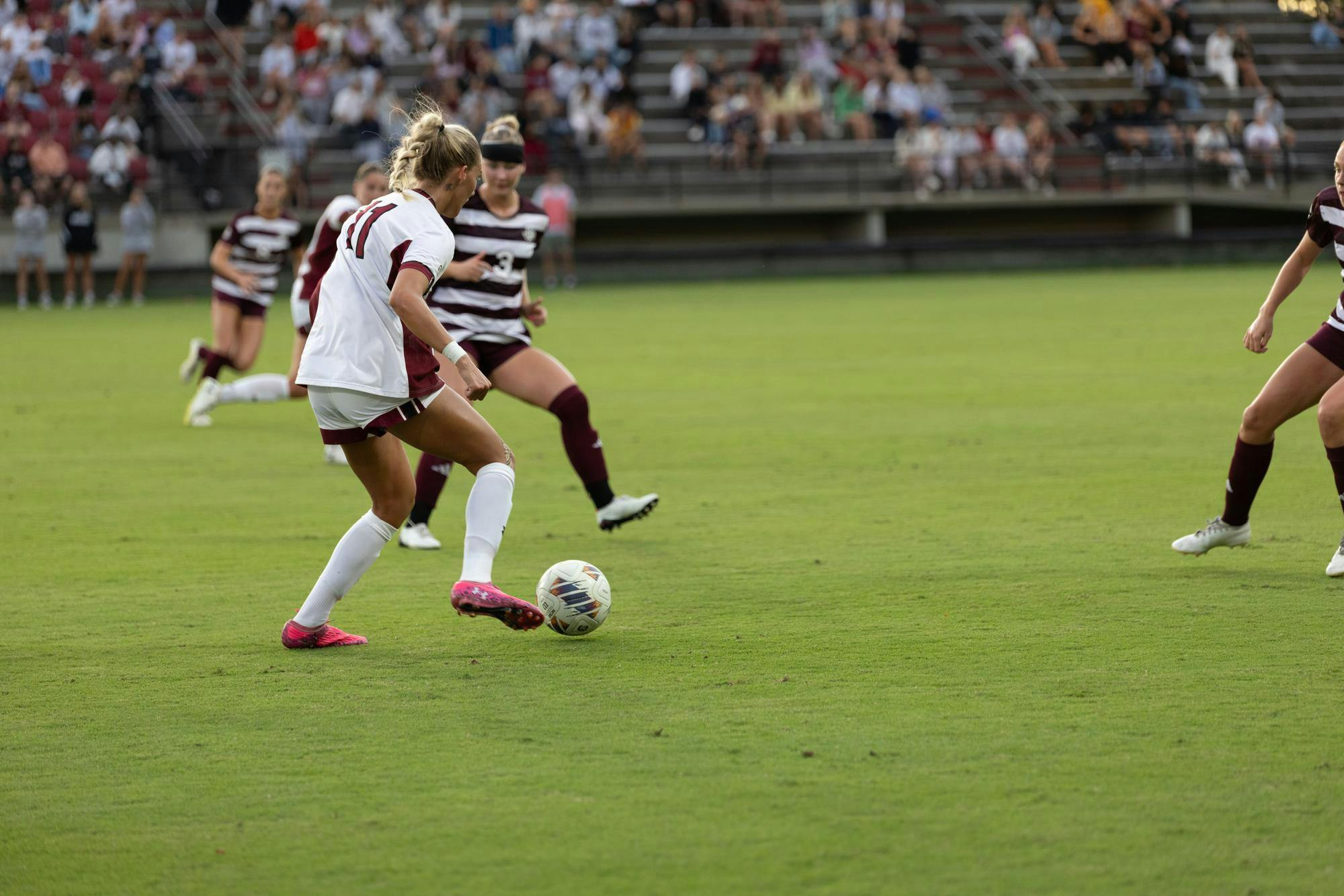 Senior midfielder Kinley Brown prepares to take on two defenders in the women’s soccer game against Texas A&amp;M on Oct. 19, 2025. Brown proceeded to pass the ball up the field to give South Carolina a chance on goal.