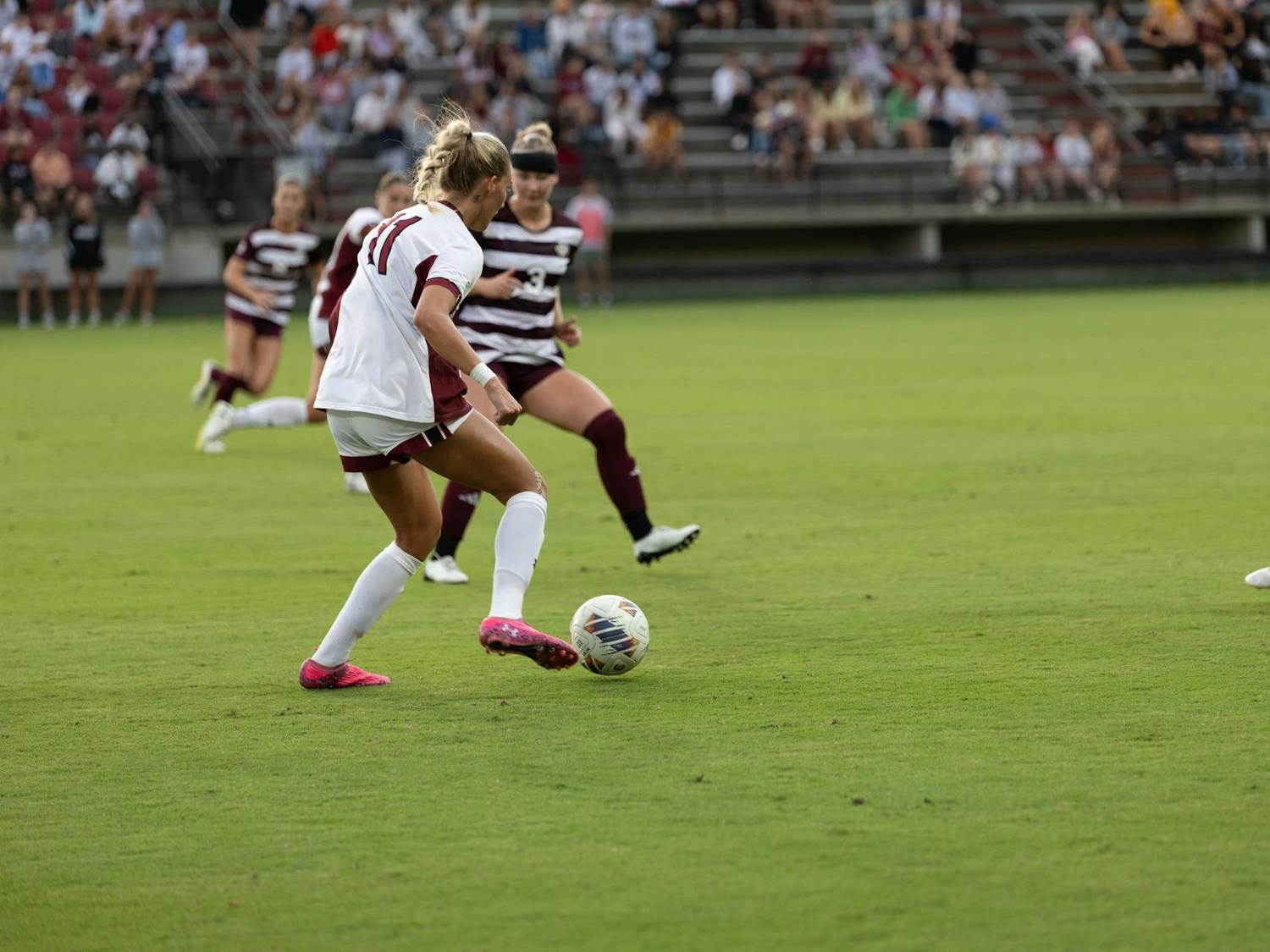 Senior midfielder Kinley Brown prepares to take on two defenders in the women’s soccer game against Texas A&M on Oct. 19, 2025. Brown proceeded to pass the ball up the field to give South Carolina a chance on goal.