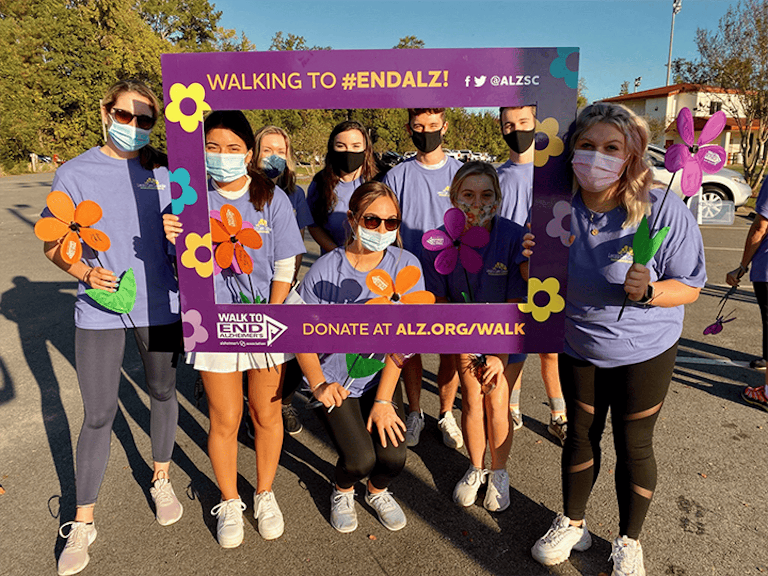  The Advocates Against Alzheimer's group poses with a frame prop during the Alzheimer's Association's "Walk to End Alzheimer's" event on Saturday, Oct. 12. 