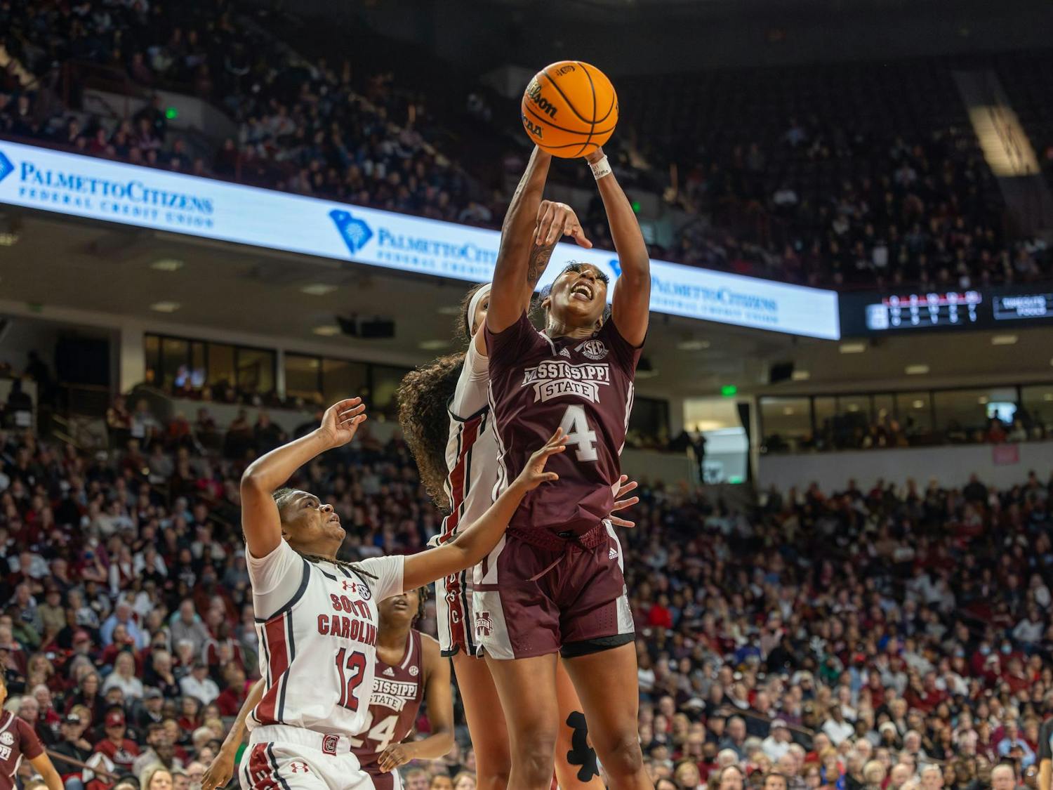 Mississippi's graduate center Jessika Carter attempts to score for the Bulldogs as South Carolina players block the shot. The South Carolina Gamecocks defeated the Mississippi State Bulldogs 85-66 Sunday in its SEC home opener.