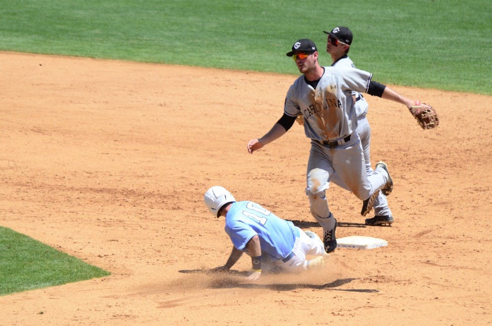 Joey Pankake leaps over a UNC player after throwing the ball to first for a double play.