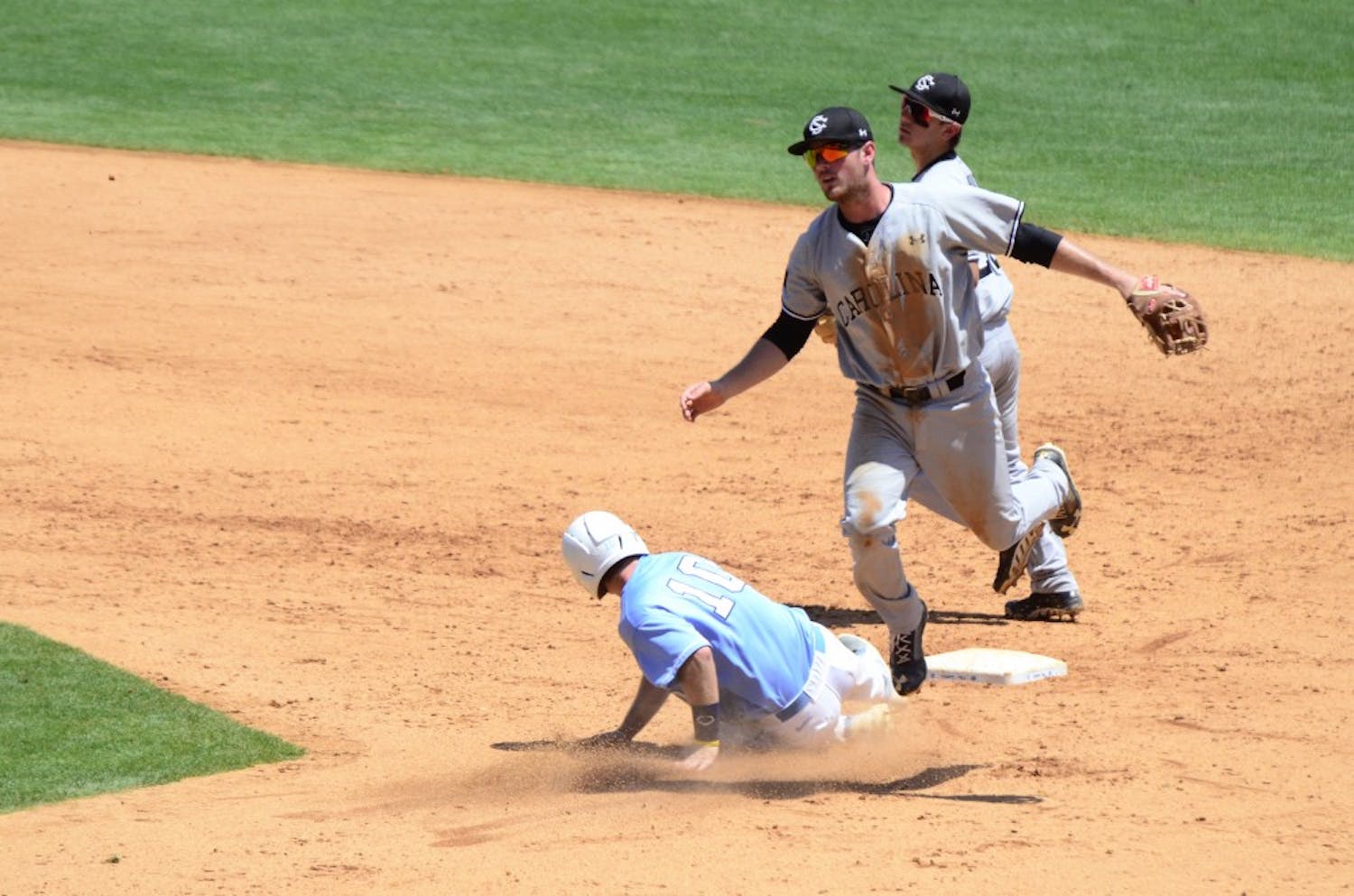 Joey Pankake leaps over a UNC player after throwing the ball to first for a double play.