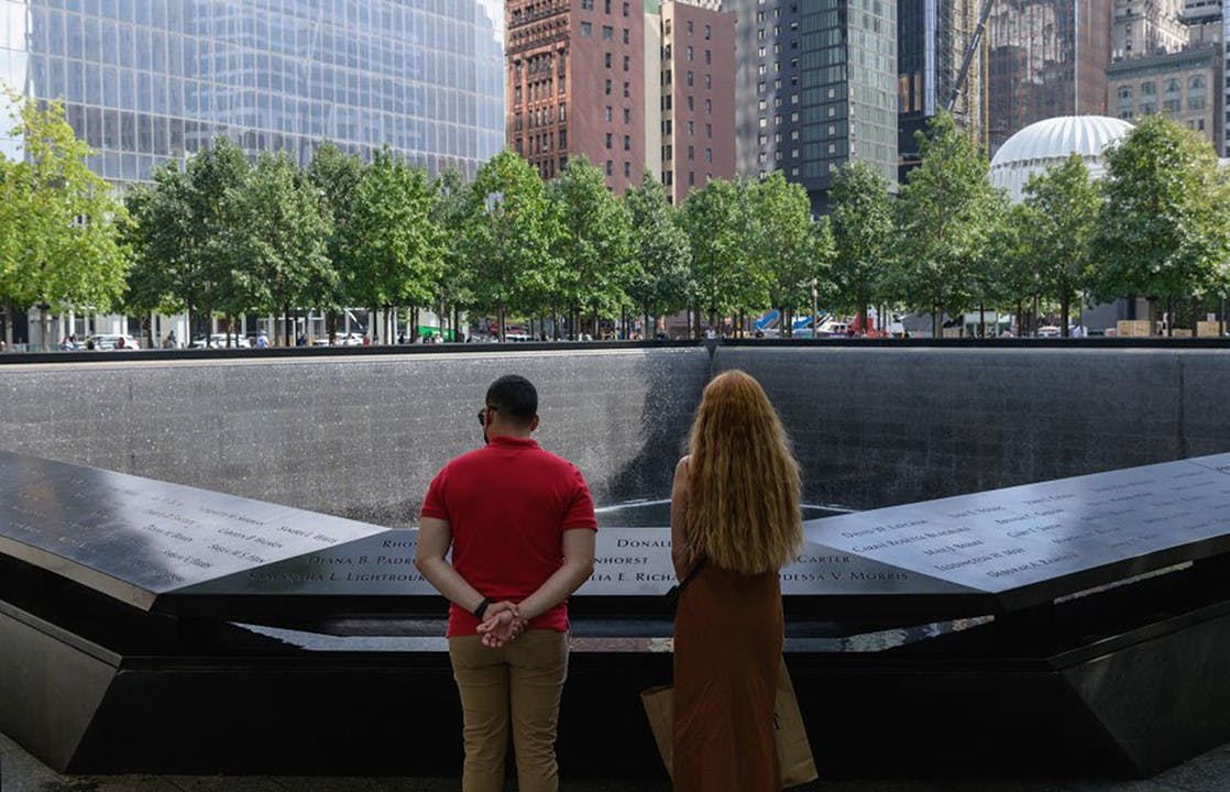 A couple stands before the National September 11 Memorial, marking the site of the south tower at the World Trade Center in New York, on September 8, 2021. (Angela Weiss/AFP via Getty Images/TNS)
