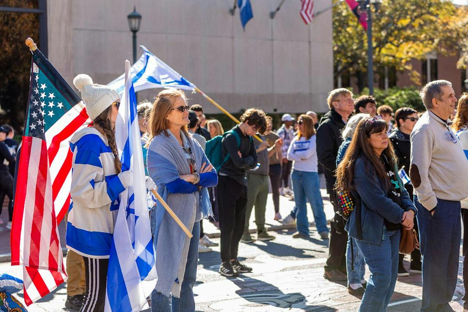 Participants stand with United States and Israeli flags during a pro-Israel rally on Greene Street on Dec. 7, 2023. Event organizers said about 200 people attended the rally in front of Russell House.