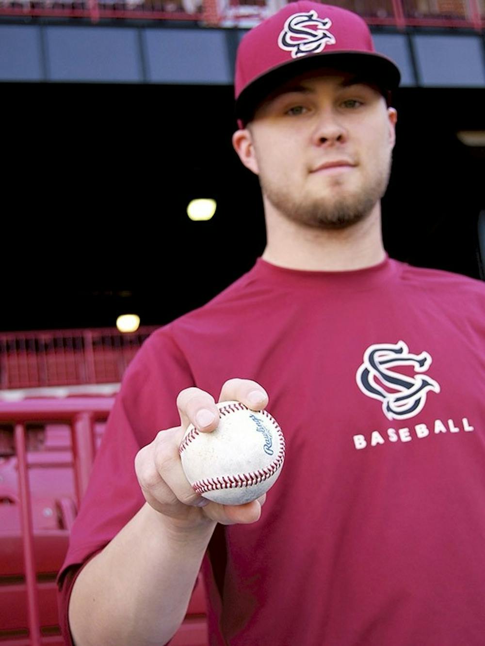 Gamecocks relief pitcher Evan Beal shows how to hold a four-seam fastball –his favorite pitch– which he can throw over 90 mph. Beal admits to being picky about the feel of the baseballs he throws.