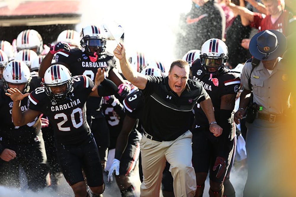 <p>Head Coach Shawn Elliott rushes out with the Gamecocks. This was Elliott's first game as Head Coach. </p>