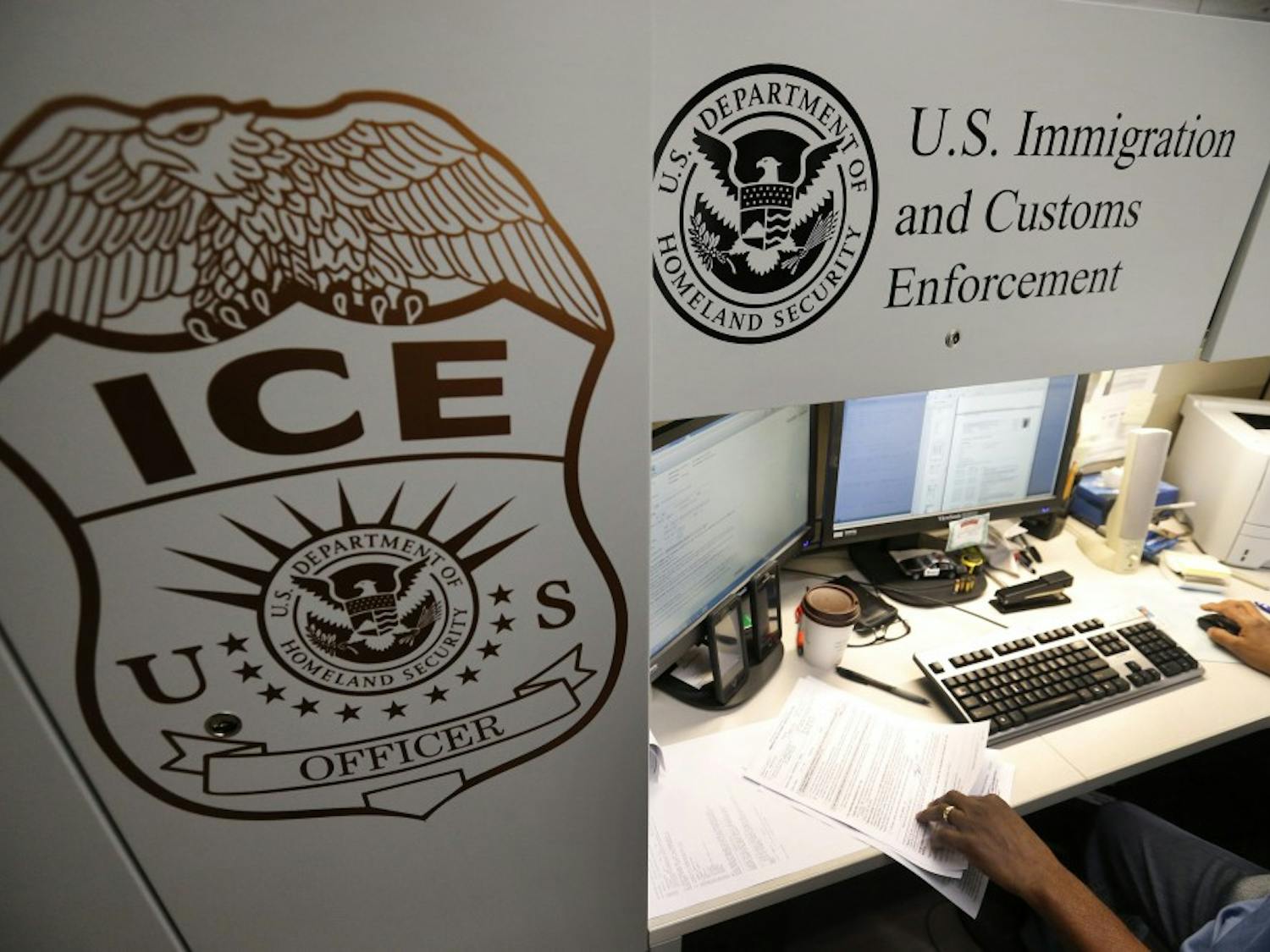 An unidentified Immigration and Customs Enforcement deportation officer reviews forms at the the Pacific Enforcement Response Center in Laguna Niguel, Calif., in an April 26, 2017, file image. (Allen J. Schaben/Los Angeles Times/TNS)