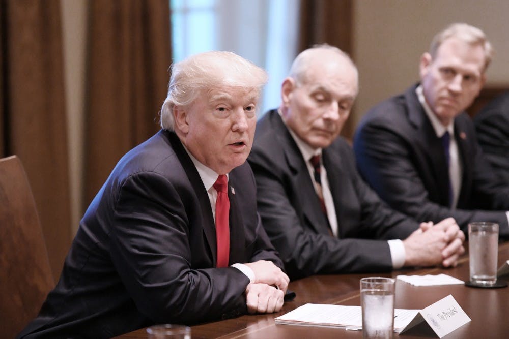 President Donald Trump speaks as White House chief of staff John Kelly looks on during a briefing with senior military leaders in the Cabinet Room at the White House in Washington, D.C., on October 5, 2017. (Olivier Douliery/Abaca Press/TNS)