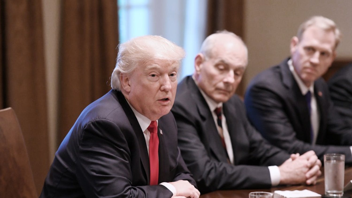 President Donald Trump speaks as White House chief of staff John Kelly looks on during a briefing with senior military leaders in the Cabinet Room at the White House in Washington, D.C., on October 5, 2017. (Olivier Douliery/Abaca Press/TNS)