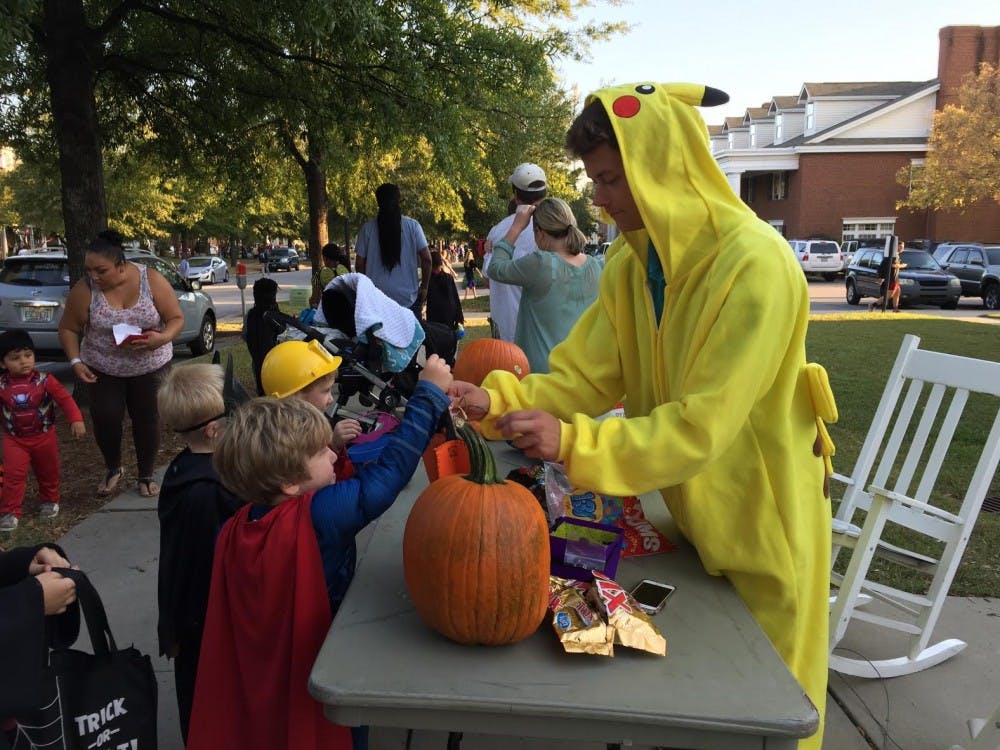 <p>Superheroes, fairies, ghosts and more receive candy handed out by members of Greek organizations.</p>