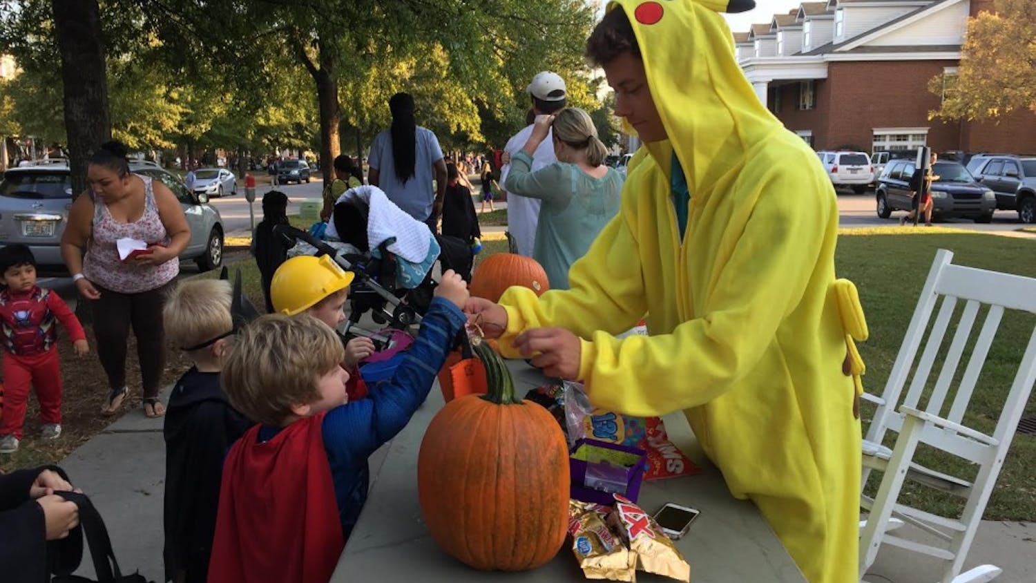 Superheroes, fairies, ghosts and more receive candy handed out by members of Greek organizations.
