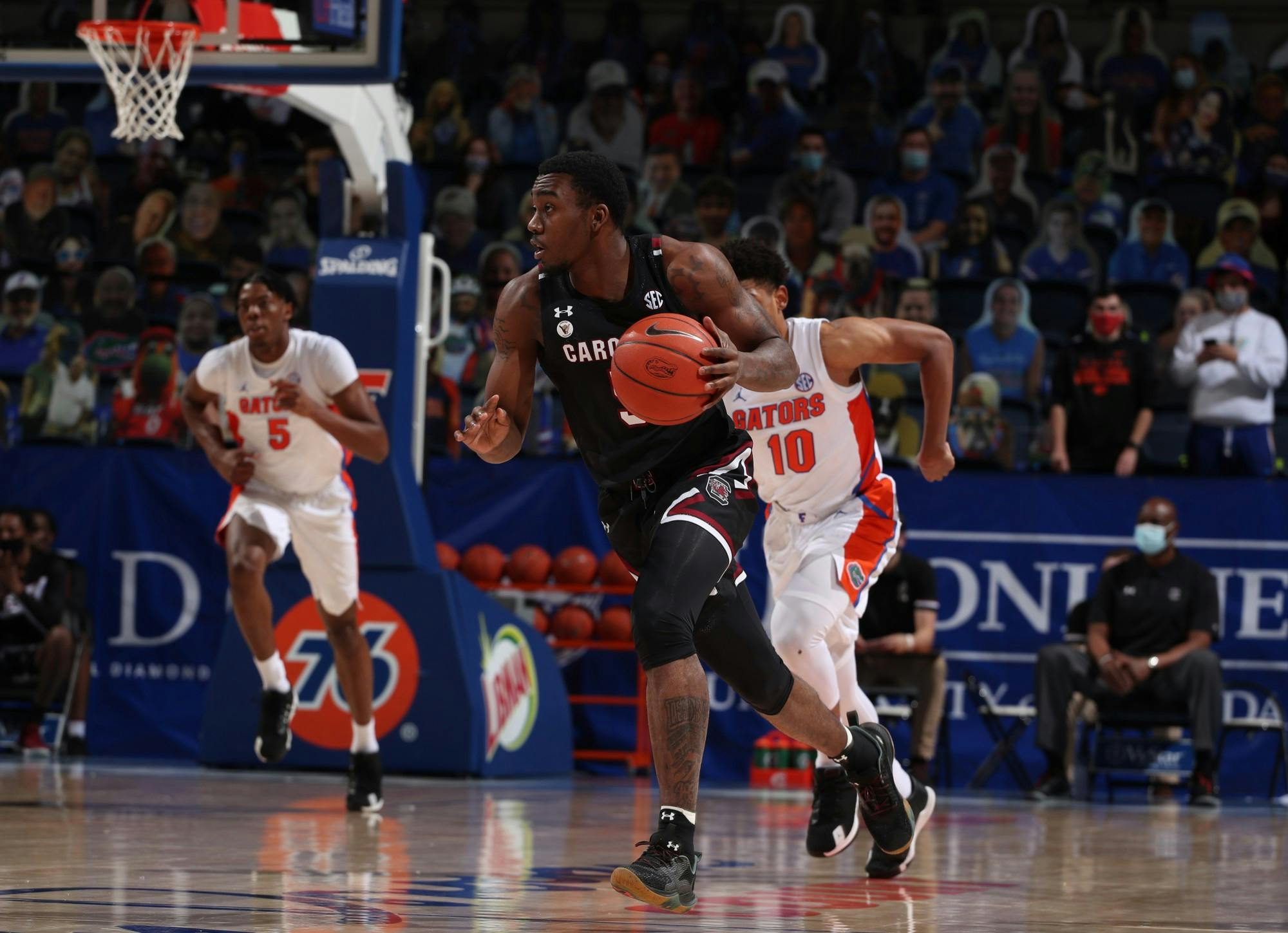 Redshirt sophomore, Jermaine Couisnard, dribbles the ball down the court as a Florida Gators player runs after him. South Carolina won the game 72-66 on Feb. 3, 2021.
