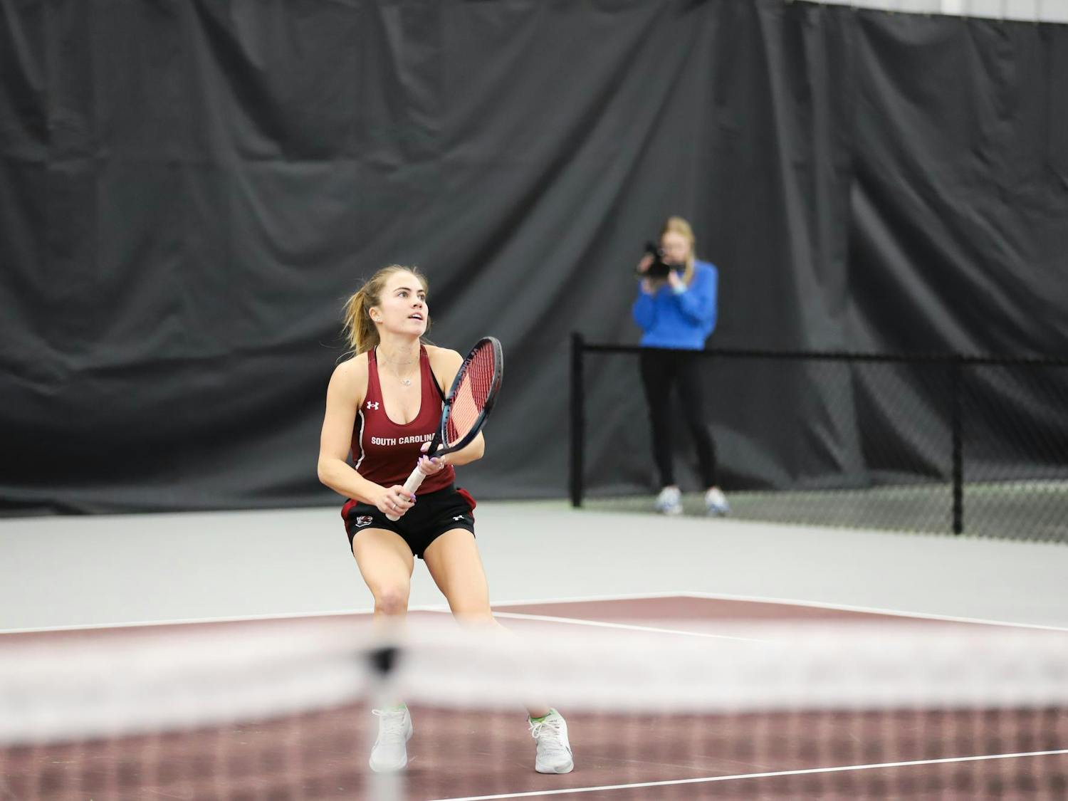 Junior Sarah Hamner lines up for a shot while playing singles on Jan. 21, 2024, at the Carolina Indoor Tennis Center. Hamner won both her singles and doubles matches against Presbyterian.