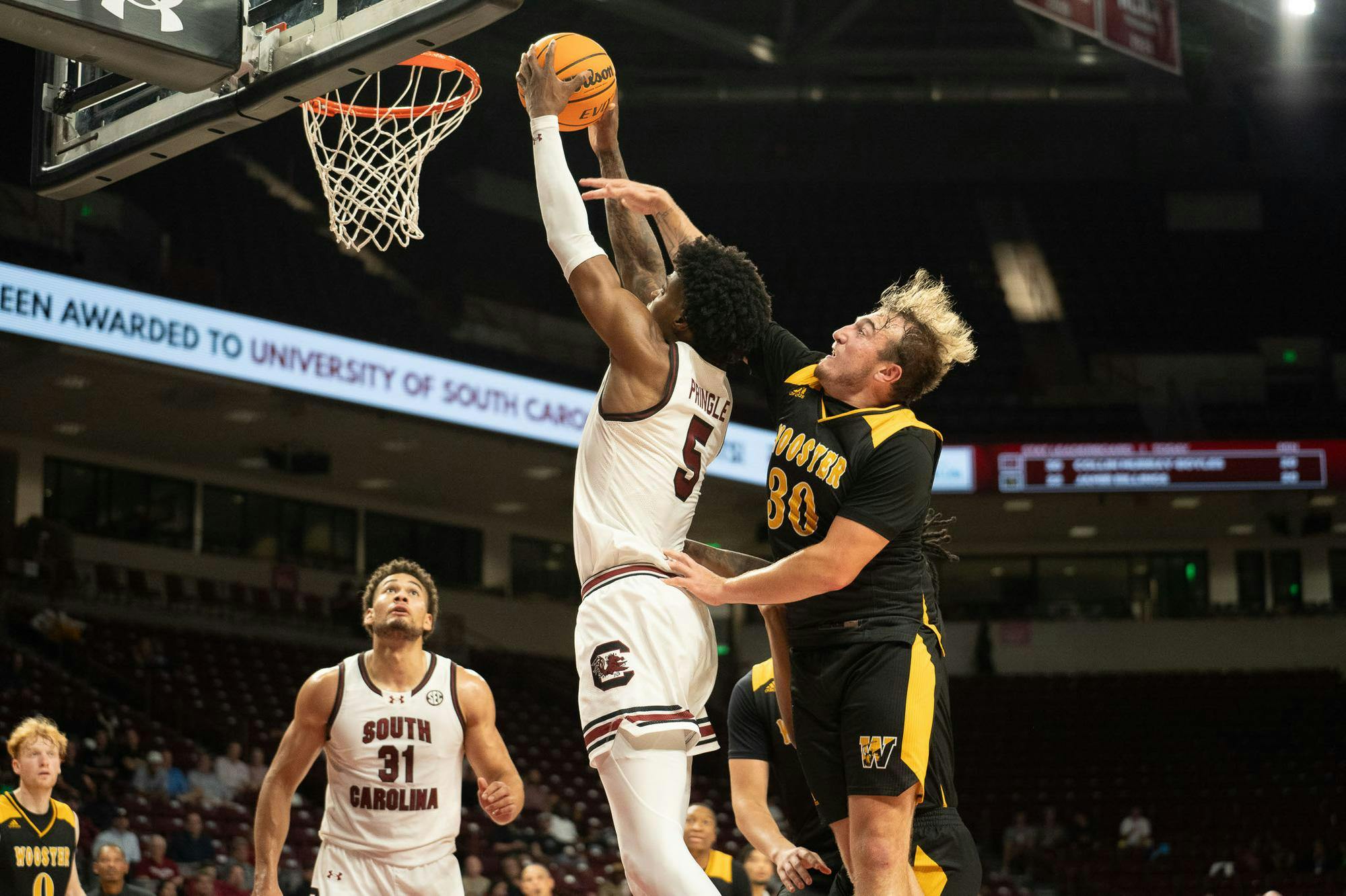 FILE — Graduate student forward Nick Pringle dunks and gets an "and-one" called after getting fouled by Wooster defenders during Oct. 30, 2024 matchup at the Colonial Life Arena. Pringle scored 13 points in the Gamecocks' game against No. 16 Indiana.