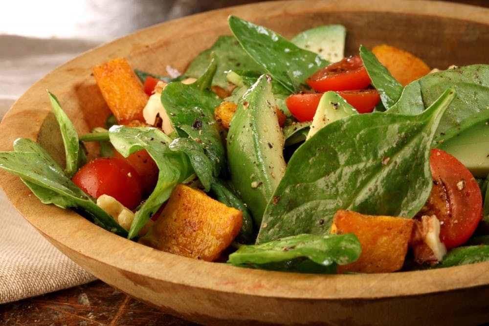 Fall's squash and summer's tomatoes make a bright, hearty salad to carry you through the change of seasons. (Michael Tercha/Chicago Tribune/TNS)