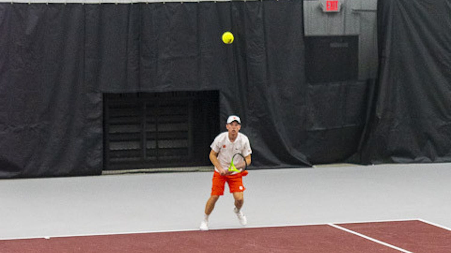 Junior Connor Thomson serves the ball over to his Clemson opponent during a doubles tournament at the Carolina Indoor Tennis Facility on Feb. 3, 2022. The Gamecocks beat the Tigers 7-0, marking the third consecutive year South Carolina has claimed the matchup.