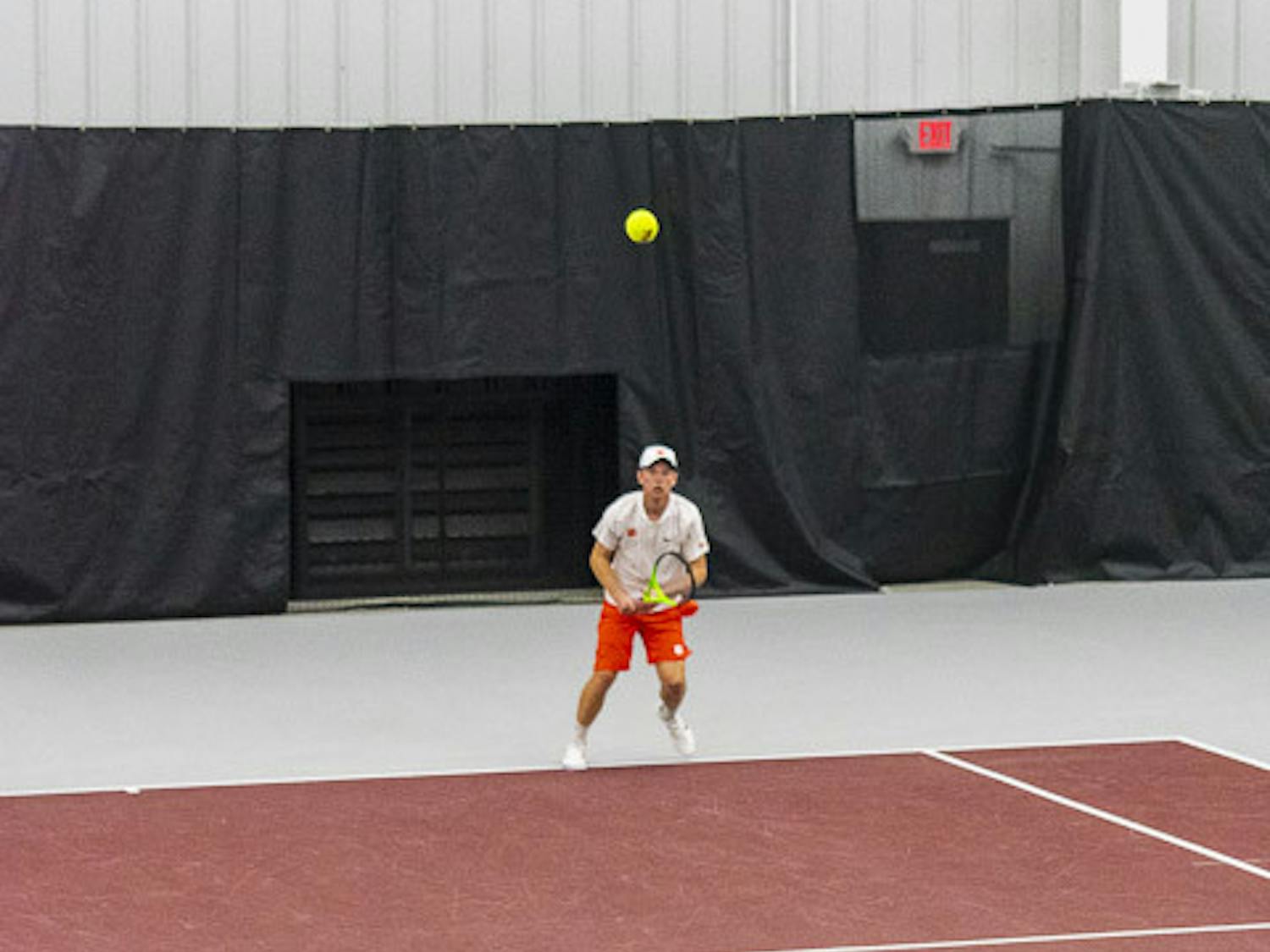 Junior Connor Thomson serves the ball over to his Clemson opponent during a doubles tournament at the Carolina Indoor Tennis Facility on Feb. 3, 2022. The Gamecocks beat the Tigers 7-0, marking the third consecutive year South Carolina has claimed the matchup.