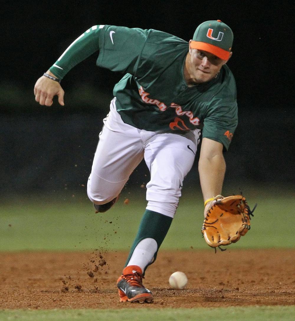 Miami&apos;s David Thompson misses an infield grounder in the third inning against Maine at Alex Rodriguez Park at Mark Light Field in Coral Gables, Fla., on Saturday, Feb. 15, 2014. Maine won, 3-1. (Al Diaz/Miami Herald/MCT)