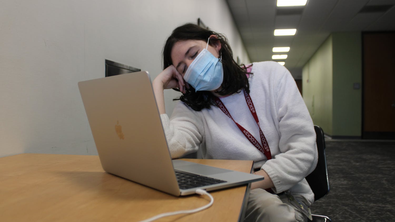 A photo illustration of second-year undecided student Bridget Blackwell fighting to stay awake while working on an assignment in Russell House on Feb. 6, 2023. After two years of online learning, students can struggle with transitioning back to in-person lectures, retaining good study habits and focusing for extended periods of time.