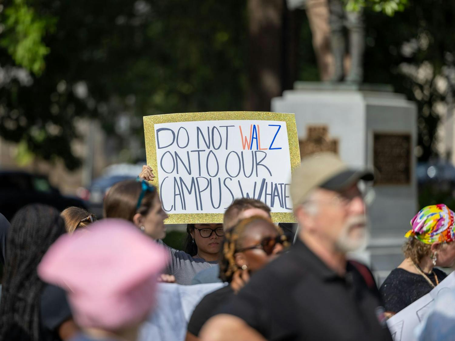 Britney Tran, first-year pharmaceutical science major at the University of South Carolina holds up a sign that said "Do not Walz onto our campus with hate" on Sept. 18, 2024 at a peaceful rally that was held at the South Carolina statehouse.