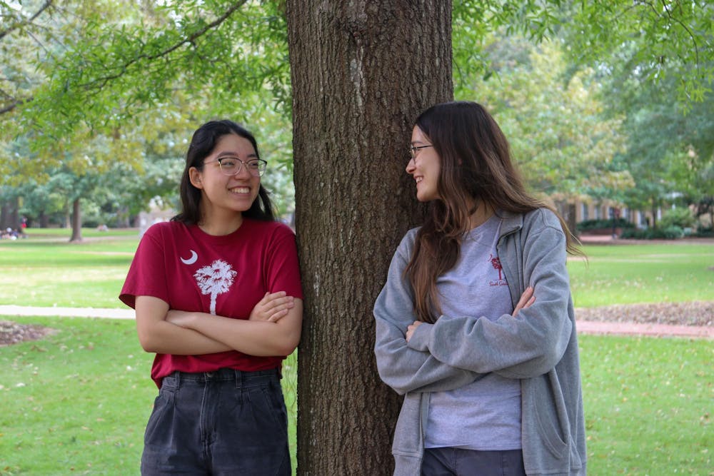 <p>Third-year biology student Gianna Mancine (left) and first-year pharmacy student Jasmine Whatley (right) pose for a picture on the Horseshoe on Oct. 4, 2024. Mancine and Whatley are the president and vice president of Cocks vs. Zombies, a club that hosts a campus-wide game of tag.</p>