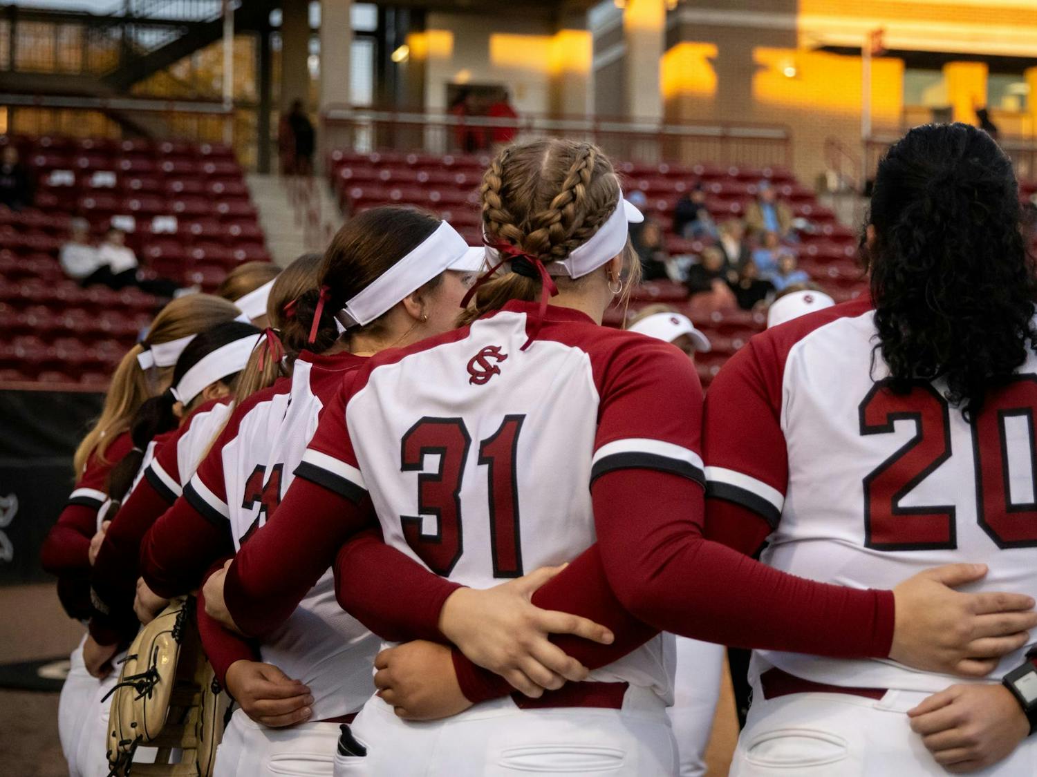 FILE — University of South Carolina softball players embrace each other during pregame festivities at Beckham Field on Feb. 19, 2025. The Gamecocks are 22-5 on the season and started the season with 20 straight wins.